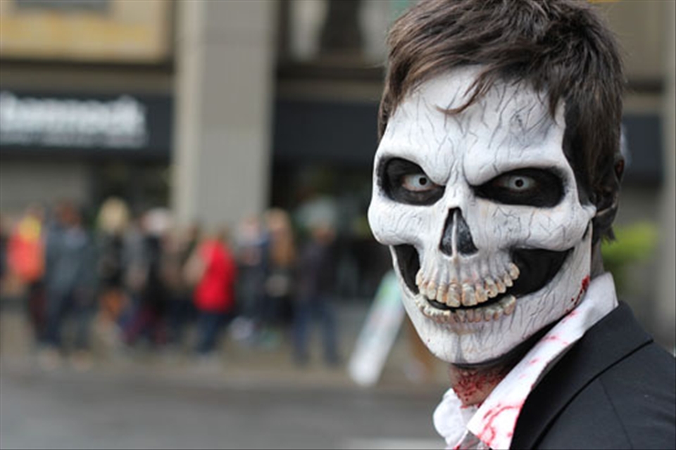 A sinister Zombie contemplates devouring innocent bystanders during Toronto's annual Zombie walk held on October 20, 2012. Zombie efforts to eat the brains of the living were incredibly entertaining and unsuccessful with the help of police guiding them along Nathan Phillips Square.