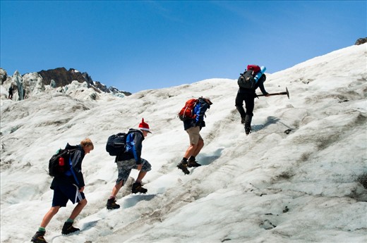 The lead guide of the group is incharge of the safety of the group. One by one each of the group members make their way up the glacier slopes guided by the path created by the leader.