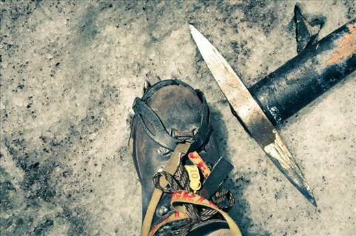 Man and his tools. Steel toe boots, crampons and a pick axe are mandatory tools to trek on ice. 
