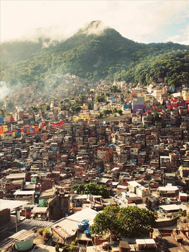 A band of colourful government built housing within in the Favela