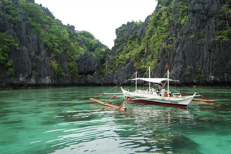 A boat is anchored near the Miniloc, one of the islands in the Bacuit Archipelago, off El Nido's coast.