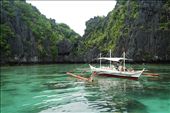 A boat is anchored near the Miniloc, one of the islands in the Bacuit Archipelago, off El Nido's coast.: by jayexiomo, Views[457]