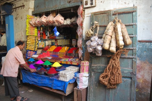 “Family business”.  This shopkeeper tidies bowls filled with colorful kum kum powder in his family business. Many of the small shops like this are passed down from one generation to the next and many of the shopkeepers seem to enjoy talking and interacting with others in the busy market. One young shopkeeper proudly showed us his personal “facebook” – a tired notebook with pictures and short messages written by travelers from all over the world who stopped by his stand over the years. A nice reminder that curiosity about other cultures and the world around us is a universal feeling.