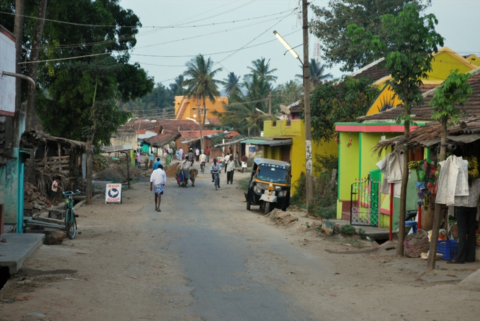 “Main Street”. The village of Saraguru is located in southern India and is a mix of old and new. Many people have cell phones but lack reliable electricity or plumbing and the road is shared between overloaded trucks, bicycles, and people and livestock walking.  Life is simpler, but it is a welcome alternative to the fast paced hustle and bustle of city life for many.