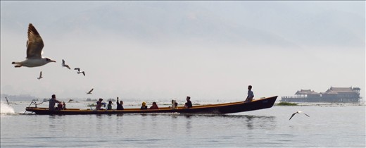 Local boat ferry on Inle Lake, feeding the birds