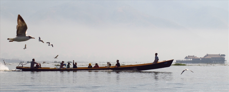 Local boat ferry on Inle Lake, feeding the birds
