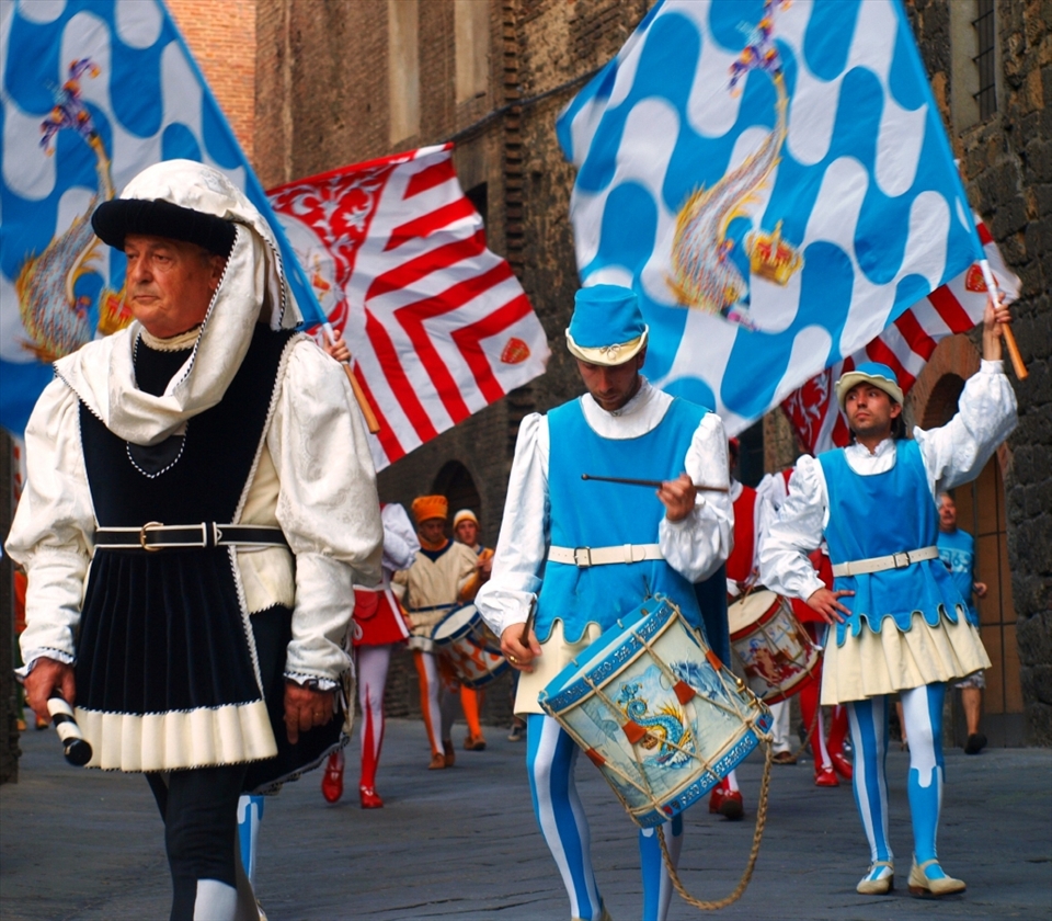 The days before the Il Palio  horserace are filled with continuous drumming and flag-waving parades in colourful and ornate costumes. There are also horse blessings where the horses are physically blessed inside a church with a crowd from the contrada. These are events taken very seriously by the locals and the traditions are passed on to each generation.