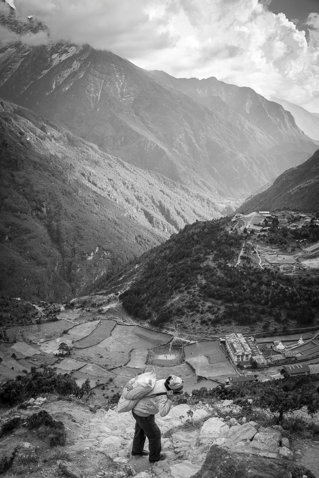 This is one of the many elderly female porters along the everest trail. She's carrying a 20 kilo sack of rice from Namche Bazaar to Tengboche, the next village on the way to base camp. It's a long 6 hour hike up a steep cliff side and then another long return trip home. 