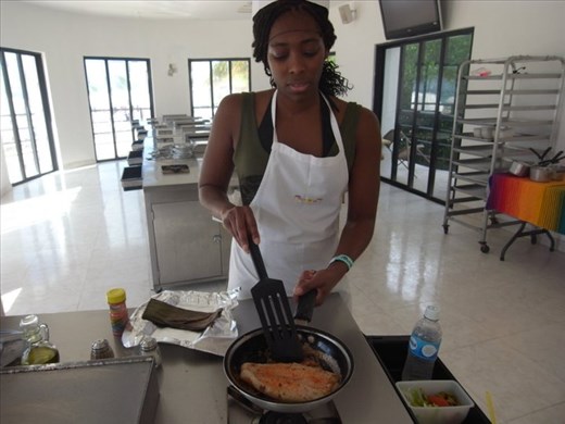 I'm cooking the fish for the first time at the cooking class in Cozumel