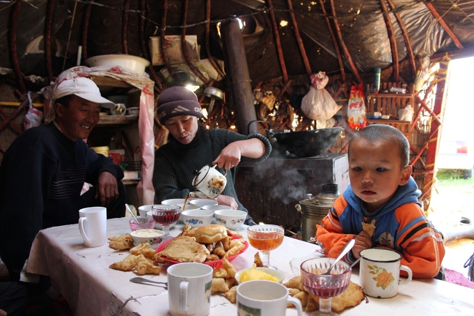 While it is a hard and sometimes lonely life, there is time for enjoying a good meal within the comforts of a yurt. The wife sits close to the kettle and pours a cup of tschai. Usually this is mixed with kumus (fermented horse milk) and sometimes some butter and salt. The self-baked bread, made in self built stone ovens, tastes best with some homemade marmalade or butter. As long as the meal lasts, the family seems to forget about life outside the yurt and the hardship of their lives. 