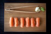 Bite-sized salmon ScandinAsian nigiri sushi in wood plank.: by jellson, Views[930]