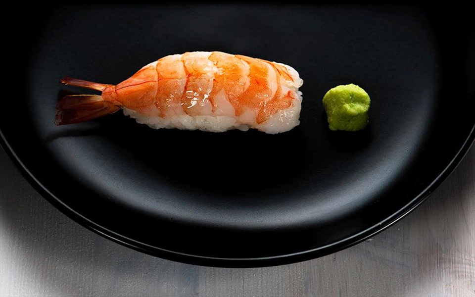 Plated bite-sized shrimp nigiri sushi.