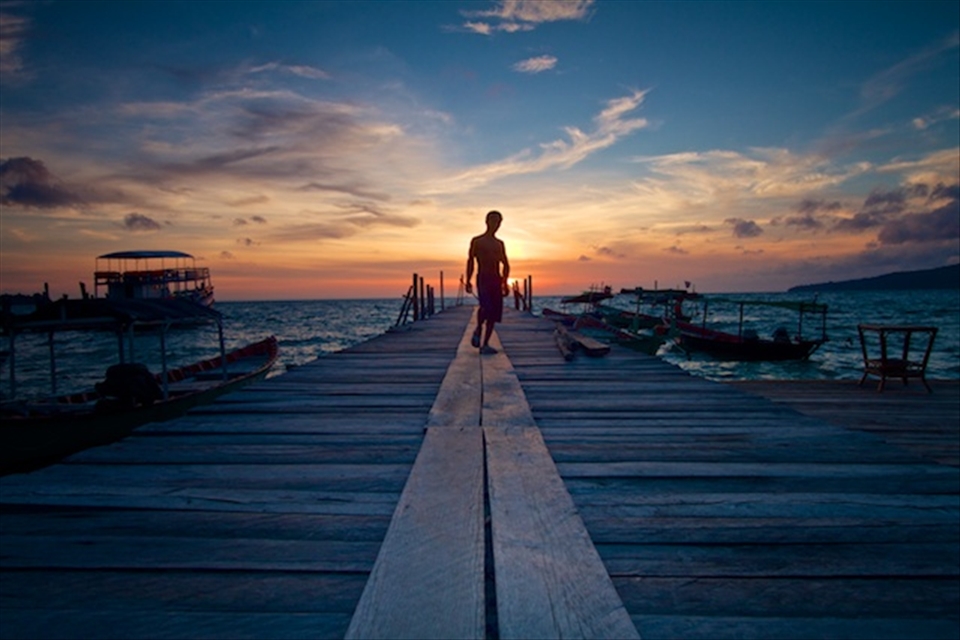 Early on Koh Rong Island, Cambodia. Lone fisherman prepares to set sail.