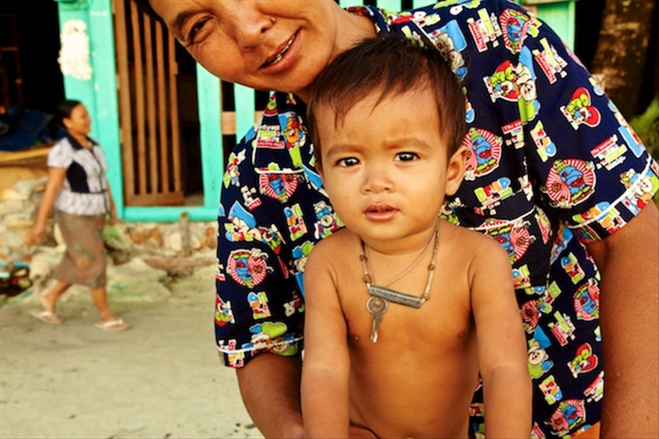 Son and mother beachside waiting for their father/husband to return from fishing