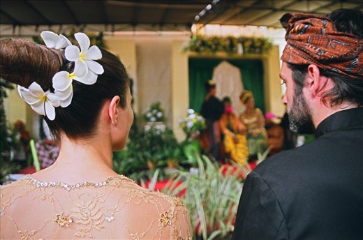 I was invited to my friend’s wedding in a small village named Merendeng in South Lombok, Indonesia.  She is Canadian and invited her friends and family to this lush beautiful island to perform the ceremony for his family in their native traditions.  Little did we know that we were to dress as bridesmaids in their traditional clothes (one size fits all) – equipped with a “doorknob” bun hairstyle circled with flowers as well!
