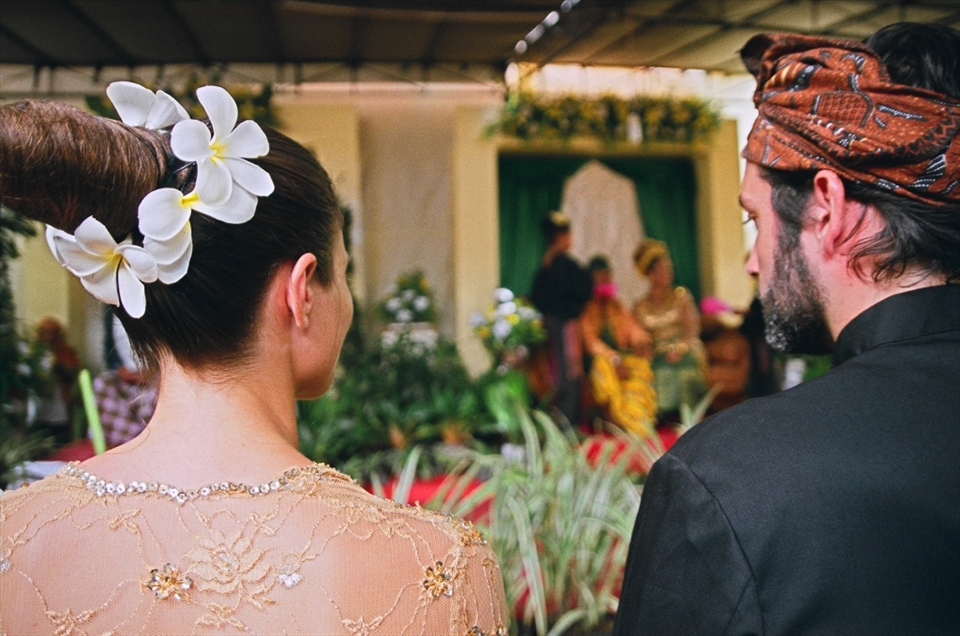 I was invited to my friend’s wedding in a small village named Merendeng in South Lombok, Indonesia.  She is Canadian and invited her friends and family to this lush beautiful island to perform the ceremony for his family in their native traditions.  Little did we know that we were to dress as bridesmaids in their traditional clothes (one size fits all) – equipped with a “doorknob” bun hairstyle circled with flowers as well!
