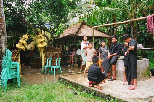 Heavy rains poured down on the celebration but everyone was able to crowd under the tarps until it passed, avoiding the holes above that would splash down on us intermittently.  A tradition of theirs is to throw the bride’s underwear on the roof of her husband’s house to ward off rain on their wedding day – it almost worked.  Many of the dirt roads remained flooded after we left.

