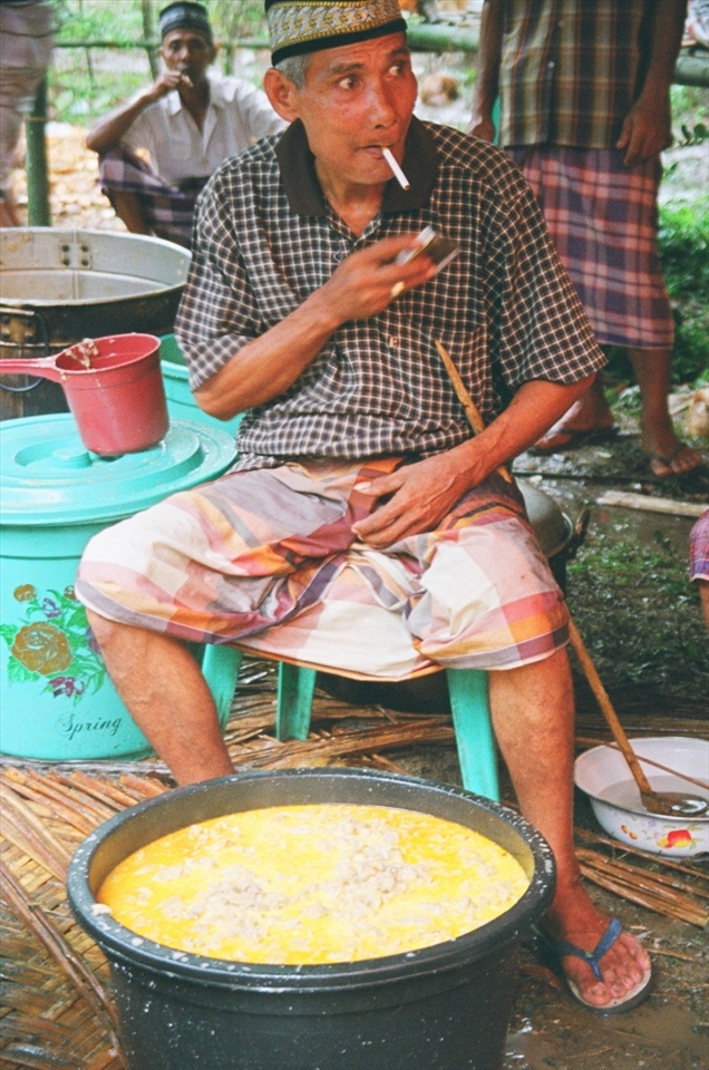 A local villager prepares food for the feast that will feed the whole village.  Cows were slaughtered out back and baskets of rice were prepared.  I found myself in the prep line at one point and was passing plates out to feed the 500 people that comprise the village.