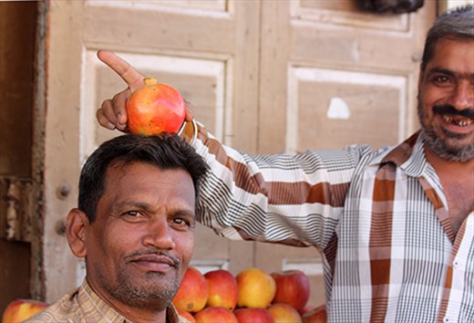 A moment of humour between two sellers of pomegranates in Palitana