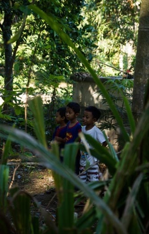 Fortunate enough to be welcomed into a small village near Sengiggi, on the island of Lombok, Indonesia, I was able to witness the community coming together for the important festival of Eid Al Adha. Some wore traditional head scarves whilst others wore board shorts.  Here younger children keep their distance from the sacrificing action, whilst others got involved, rituals being passed from generation to generation. 