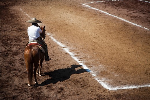 Alone, warming up his horse before the event.