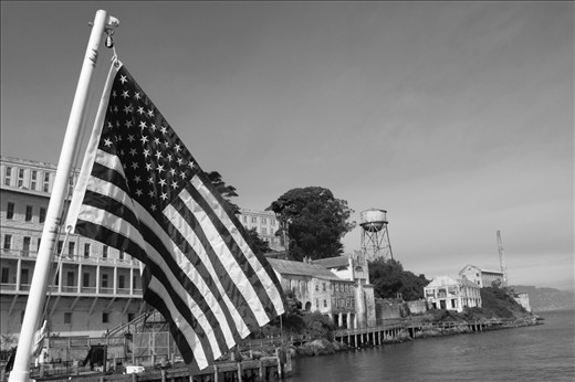 The USA flag on top a boat as it arrives to Alcatraz, an abandoned prison