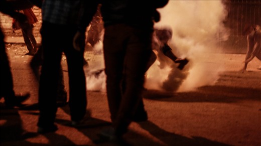 As the protests grow in Tahrir, an offshoot battle with police takes place not 500 meters away. Teenage boys and young men fill Simon Bolivar Square, where the anger with the presidency boils over. Tear gas fired by police fills the street and fearless protesters grab them one by one to throw back. Adrenaline drives the people in waves, reacting in unison.  