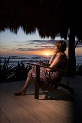A tourist from New Zealand watches the surf at sunset from a restaurant deck.  

The surf,  beaches, food and friendly locals make Jiquillio a perfect tourist destination.  Fortunately the money that comes with them funds turtle conservation projects.  : by jessewillson, Views[241]