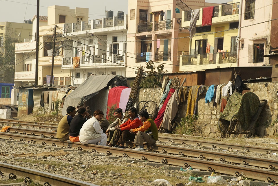 The tracks make perfect benches when it's break time for the men who live in and near the slums of Haridwar, India. 