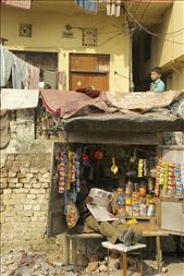 A railway quick stop owner rests with a newspaper, just below his home where his son awaits a train.: by jessicajhill, Views[676]