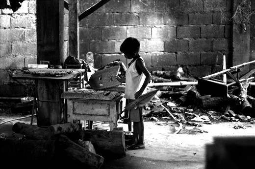 a child observing an inmate's handicraft