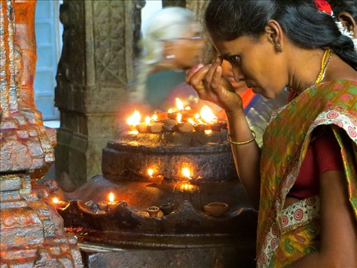 A devotee focused only on the worship of her deity at Meenakshi Temple.