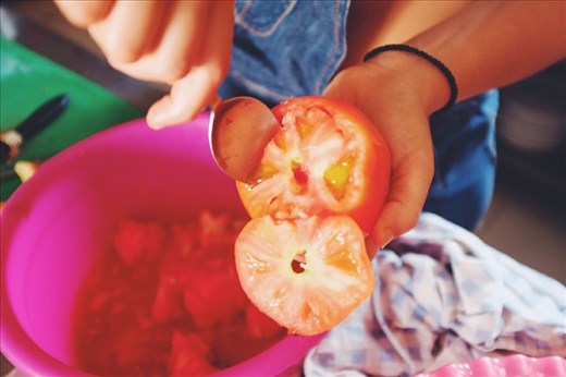 Use a spoon to carefully scoop out the flesh of the tomato - remember to keep!