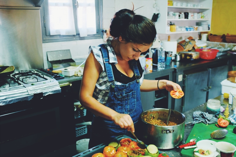 Epifania stuffing the tomatoes in the kitchen of her family's Taverna