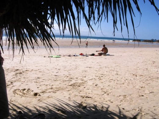 Chilled. A surfie gives up the waves and his friends for a while to chill on the beach with his guitar. The ultimate picture of a laid-back beach culture. 