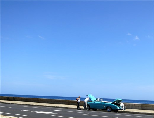 Repairs: Havana is filled with old buildings, cars and electronics. Most Cubans are very good at repairing things with very little given how old so much of what they use in their daily life is. This picture was taken on the Malecon as three men surrounded a broken down 50's car (an icon of Cuba in itself). 