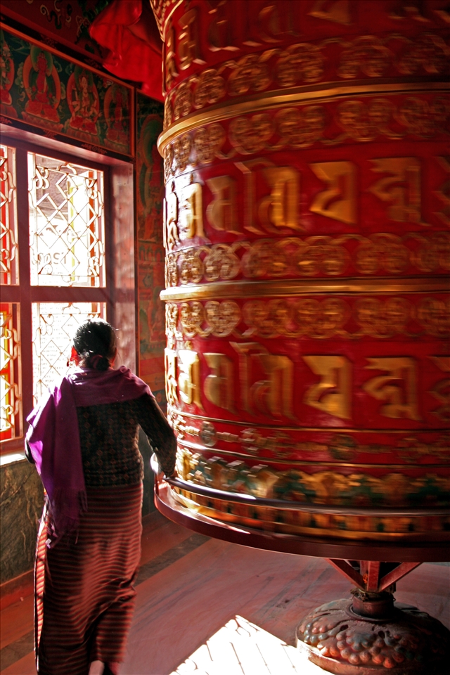 Spinning the prayer wheel, carrying prayers to heaven 