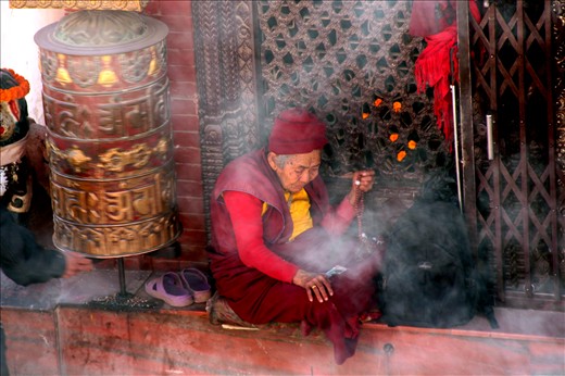 Surrounded by incense and wood smoke at Bodhnath Stupa 