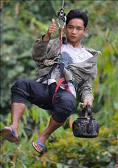 One of the most exhilarating experiences you can have. The Gibbon Experence in Laos. After a 5 minute demonstration, you find yourself ziplining 500m between valleys and hundreds of metres above ground - with the most basic of breaking systems.. an old bike tire placed on the line which you apply pressure to slow yourself down - pure adrenaline!  

This picture is of our guide zipping in to deliver us our morning coffee to our treehouse!: by jodyslens, Views[374]
