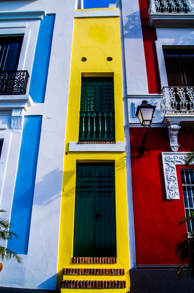 This is the smallest building of the world located at San Juan, Puerto Rico. It's quite colorful and cheerful, but the fun thing about it is that people actually live there and when the doors are open you can see the entire inside of the building.