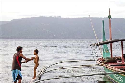 Life on Taal Volcano island remains mundane with limited resources and few opportunites for improving quality of living and well-being. After a long day of catering to tourists and thrillseekers, a father spends his evening with son bathing him on their family boat along the shore of the island.