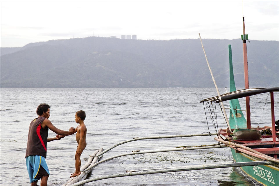 Life on Taal Volcano island remains mundane with limited resources and few opportunites for improving quality of living and well-being. After a long day of catering to tourists and thrillseekers, a father spends his evening with son bathing him on their family boat along the shore of the island.