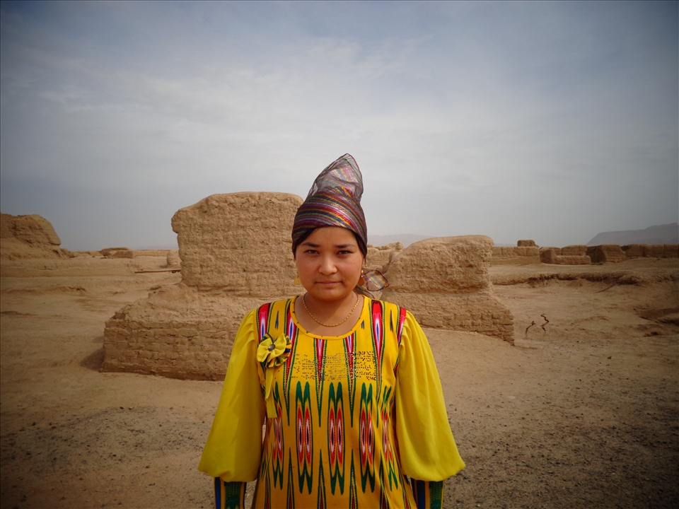 A Uyghur girl stands with the ruins of her ancestor’s ancient city.