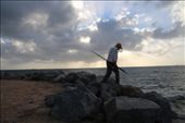 A causal fisherman at work. After the day job, a man is seeing carrying a fishing rod, still lingering on his hobbies with sunset at the background. : by johnsonlens, Views[472]