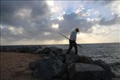 A causal fisherman at work. After the day job, a man is seeing carrying a fishing rod, still lingering on his hobbies with sunset at the background. : by johnsonlens, Views[601]