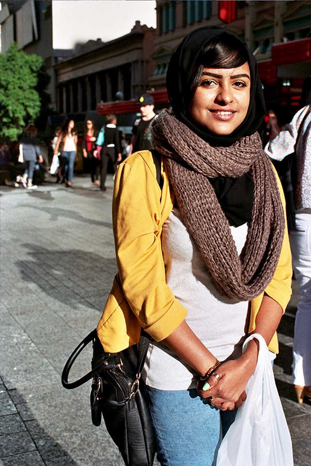 A gift is given.
Casually pacing through the mall, a vibrant yellow movement flickers far off in the direction of my path. I immediately recognise the need for her portrait. Learning from past mistakes, I approach my subject head on. Observing me struggle while determining my shutter, Mary’s persona subsides, allowing me to capture truth. 