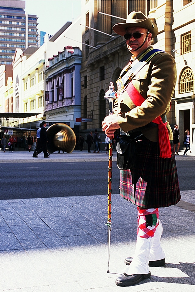 Veteran.
Take your camera with you everywhere; The first lesson. When stumbling across the path of a Vietnam Veteran's march, excitement fills me. Velvia in hand, I set out to find a willing subject for a portrait. Multiple friendly declines later, my view settles upon a lone Veteran preparing towards the back of company. Conversation proceeds; He accepts.