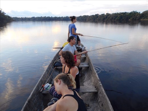 Our jungle group fishing for dinner. Just a tree stick and line, no rod or reel out here.
