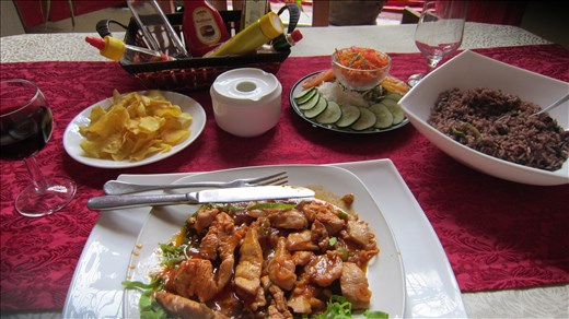 A typical Cuban meal, chicken in salsa, rice with black beans