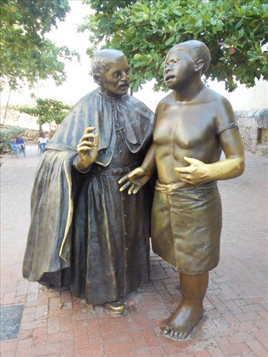 Bronze statues in front of Cathedral de San Pedro Claver. San Pedro helping an Angolan slave, 2m tall. It's set at ground level (not on a pedestal) so it's accessible to people on the street like San Pedro was in real life.